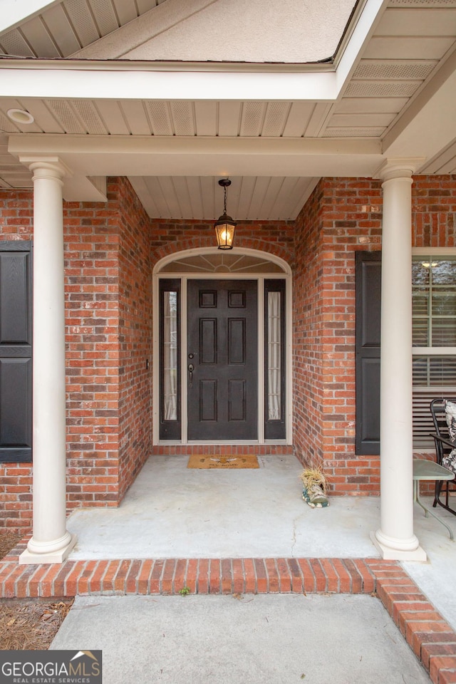 view of exterior entry with a porch