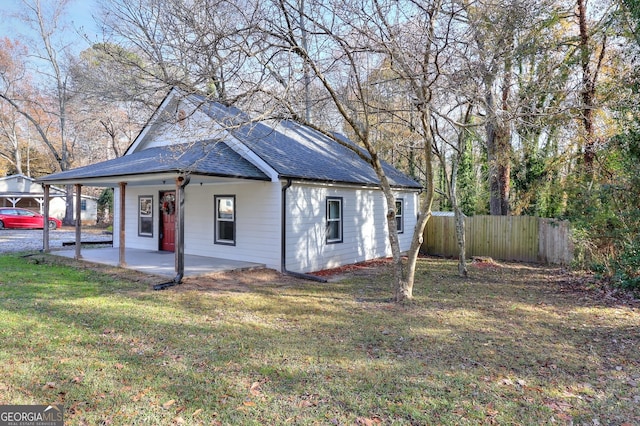 view of front of house with a patio and a front yard