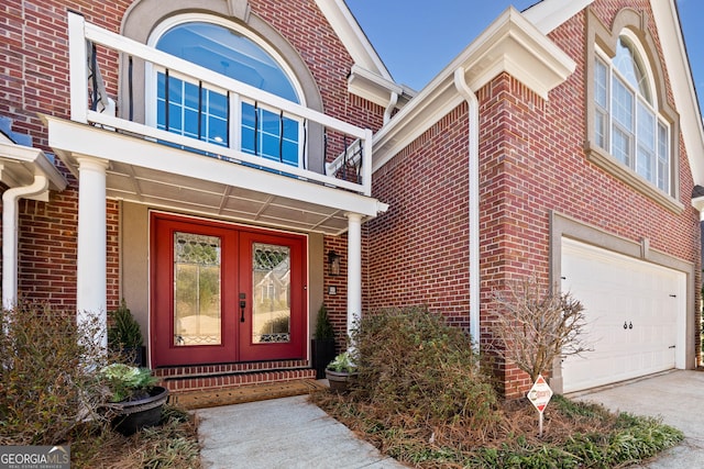 entrance to property featuring a garage and french doors