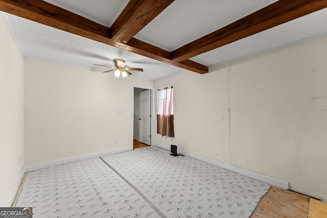 spare room with ceiling fan and beam ceiling