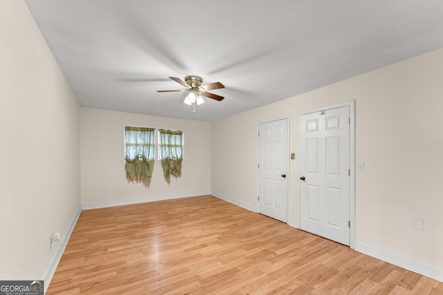 unfurnished bedroom with ceiling fan and light hardwood / wood-style flooring