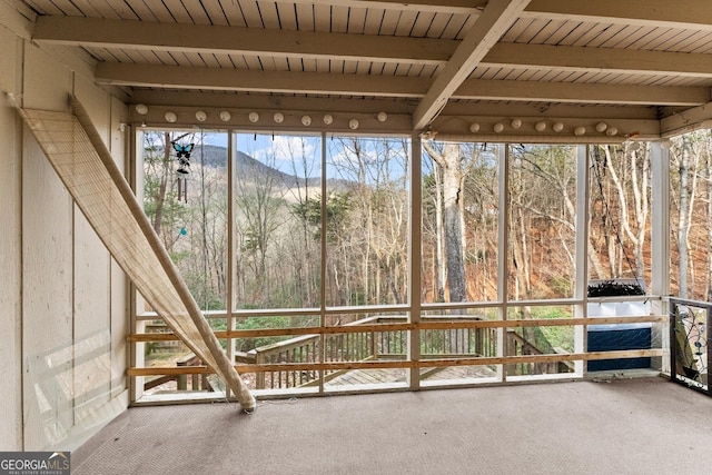 unfurnished sunroom with wood ceiling and beam ceiling