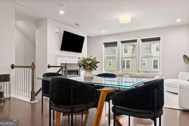 dining space with dark hardwood / wood-style flooring