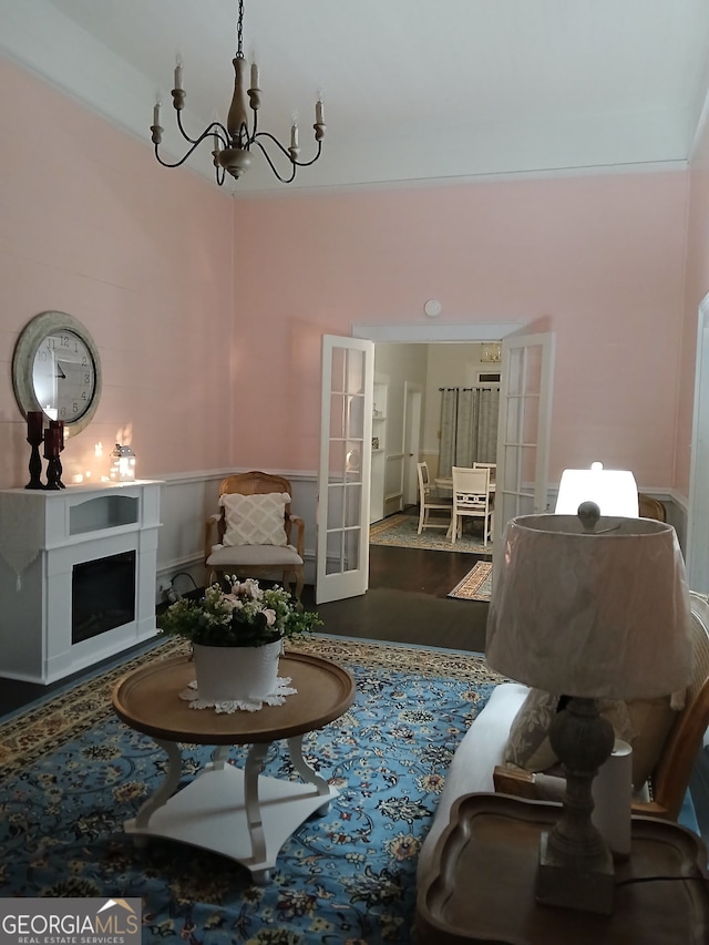 sitting room with a notable chandelier and hardwood / wood-style floors