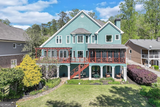 6780 Lawson Cir, Gainesville, GA 30506 - back of house featuring a chimney, a lawn, stairway, a sunroom, and stucco siding