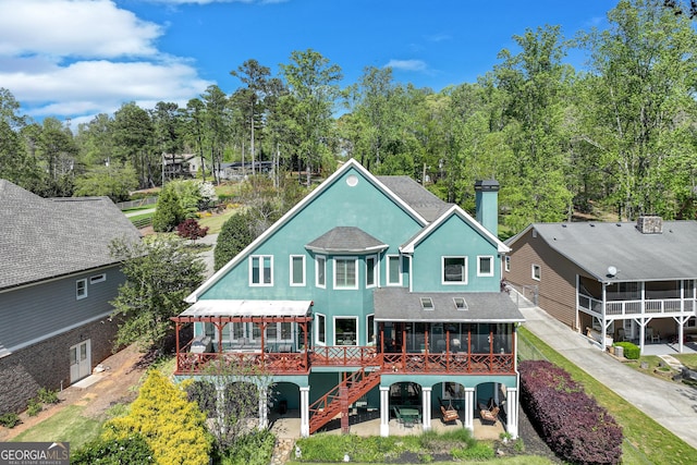 6780 Lawson Cir, Gainesville, GA 30506 - back of house with a chimney, a sunroom, stairs, and stucco siding