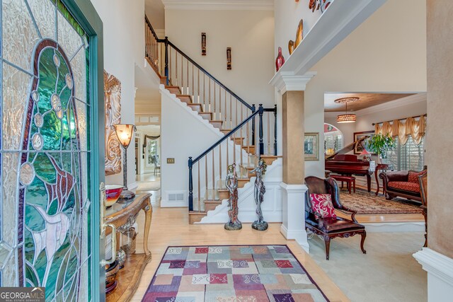 6780 Lawson Cir, Gainesville, GA 30506 - foyer with stairway, a high ceiling, crown molding, and visible vents