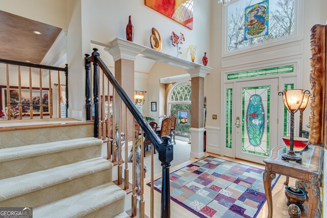 6780 Lawson Cir, Gainesville, GA 30506 - foyer entrance featuring ornate columns, a towering ceiling, stairway, and a decorative wall