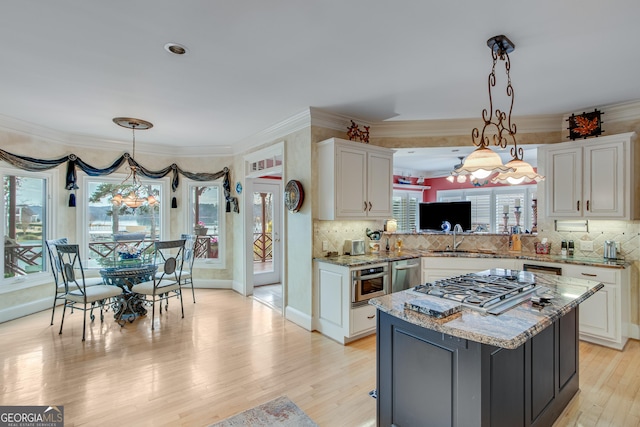 6780 Lawson Cir, Gainesville, GA 30506 - kitchen featuring stainless steel appliances, a center island, a sink, light wood-style floors, and white cabinetry