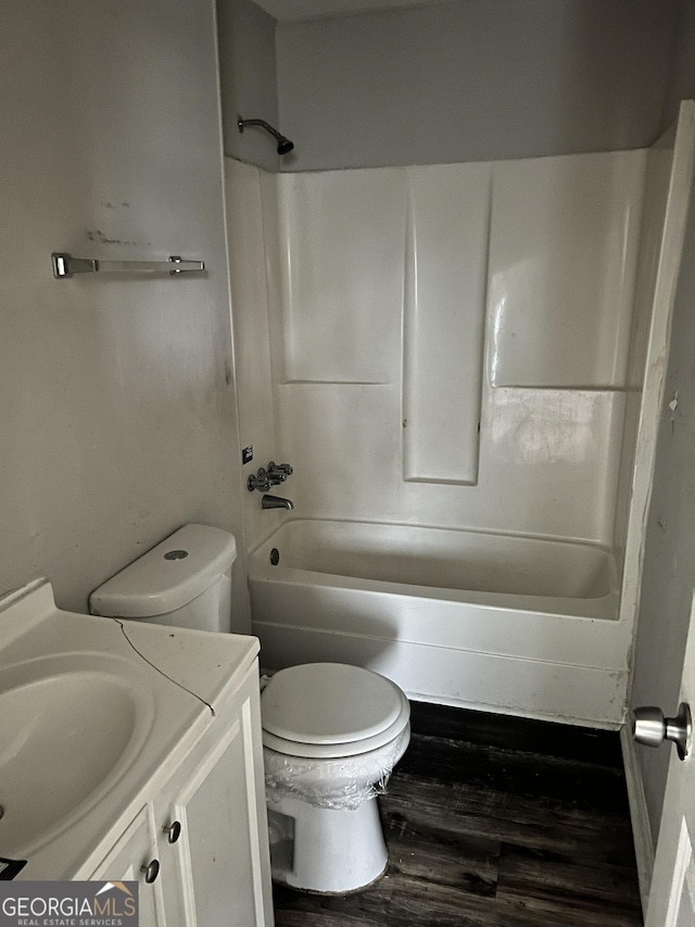 full bathroom featuring shower / bathing tub combination, vanity, hardwood / wood-style floors, and toilet