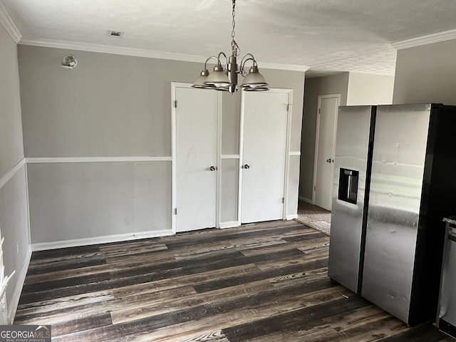 unfurnished dining area featuring ornamental molding, a chandelier, a textured ceiling, and dark hardwood / wood-style flooring