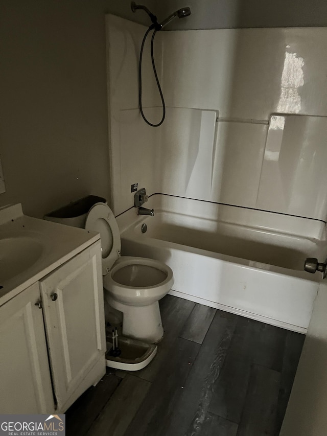 full bathroom featuring vanity, hardwood / wood-style flooring,  shower combination, and toilet