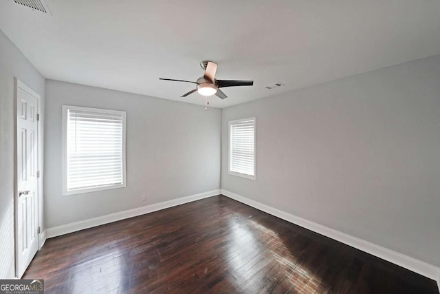 empty room with dark hardwood / wood-style floors and ceiling fan