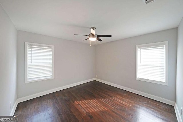 unfurnished room featuring dark wood-type flooring and ceiling fan