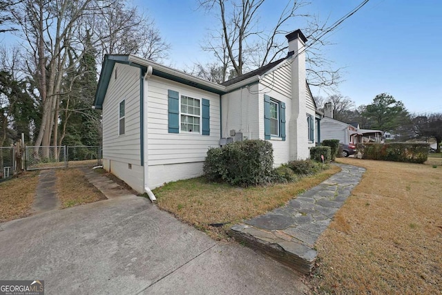 view of side of property with a lawn