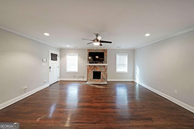 unfurnished living room with dark hardwood / wood-style flooring, ceiling fan, plenty of natural light, and a high end fireplace