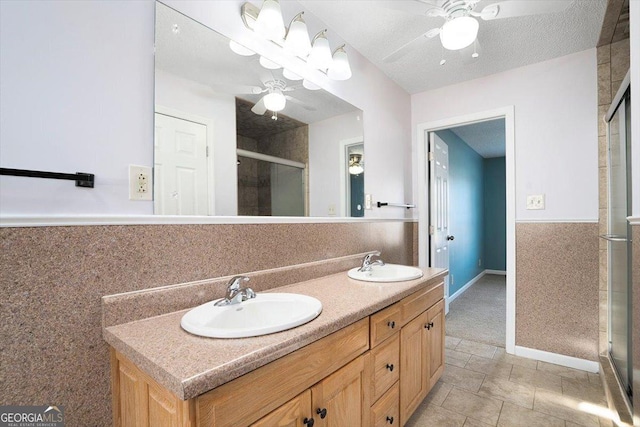 bathroom with vanity, ceiling fan, and walk in shower