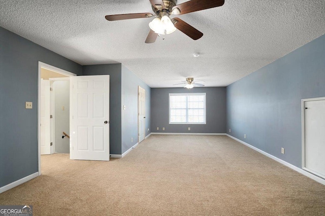 carpeted empty room with a textured ceiling