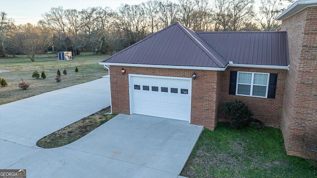 property exterior at dusk with a garage and a yard