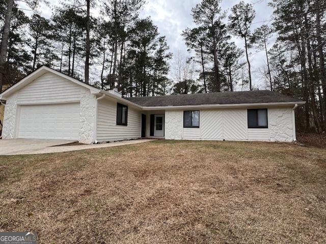 single story home with a garage and a front yard