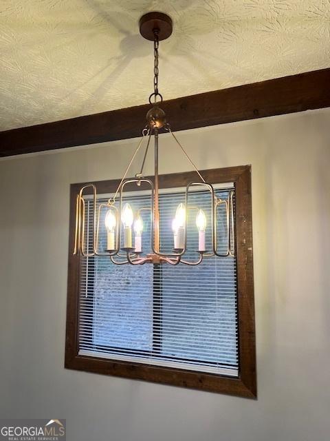 room details with beamed ceiling and a textured ceiling