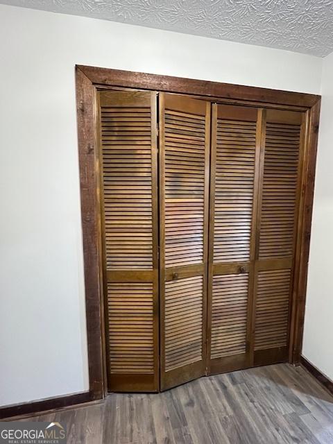 details with hardwood / wood-style floors and a textured ceiling