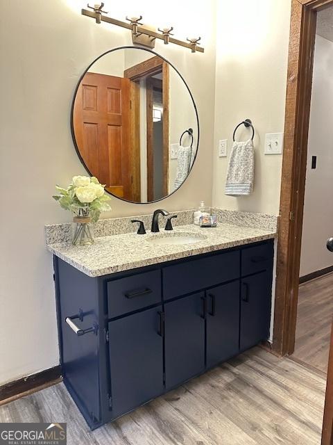 bathroom featuring vanity and hardwood / wood-style flooring