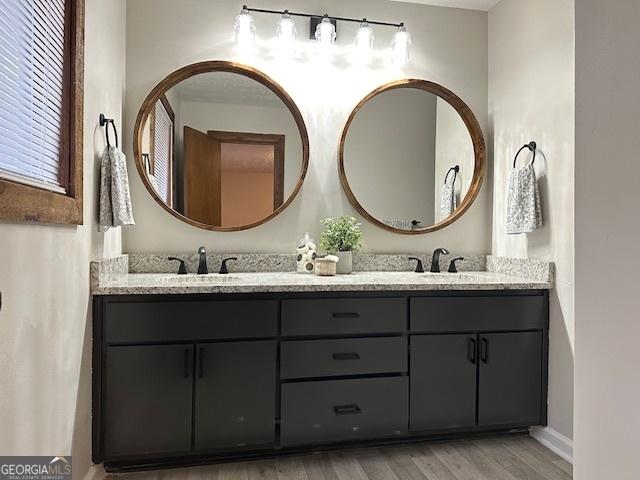 bathroom with vanity and hardwood / wood-style flooring