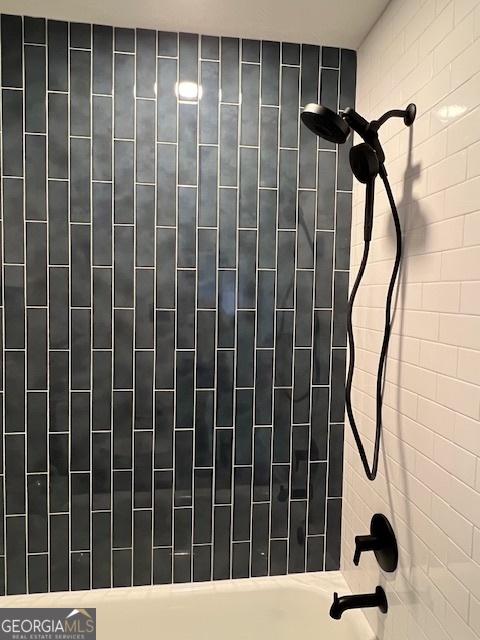 details with tiled shower / bath combo