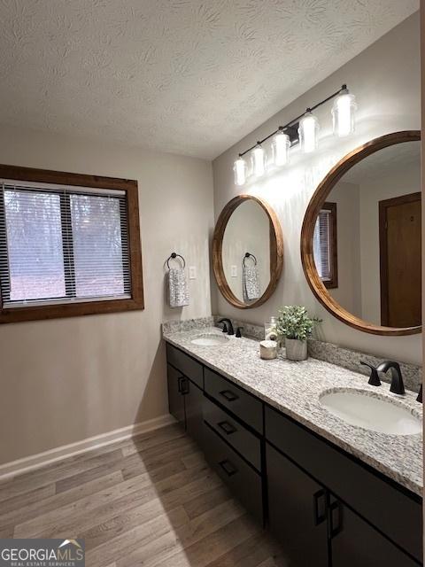 bathroom with vanity, hardwood / wood-style floors, and a textured ceiling