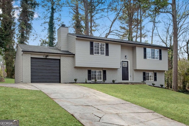 bi-level home featuring a garage and a front yard