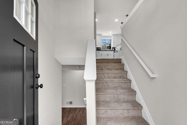 staircase featuring wood-type flooring