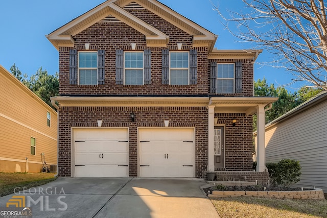 traditional-style house featuring concrete driveway, brick siding, and an attached garage