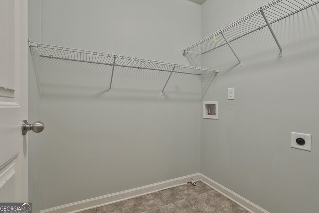 laundry room featuring laundry area, hookup for a washing machine, baseboards, and electric dryer hookup