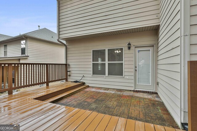 wooden terrace with a patio