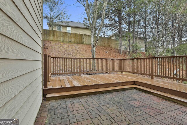 deck with a patio area and a fenced backyard