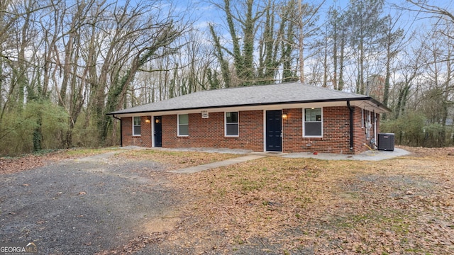 ranch-style home featuring central AC unit