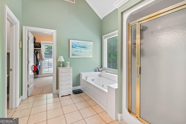 bathroom featuring tile patterned flooring, ornamental molding, separate shower and tub, and vaulted ceiling