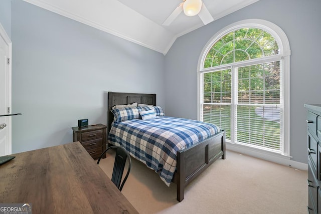 carpeted bedroom with ceiling fan and vaulted ceiling