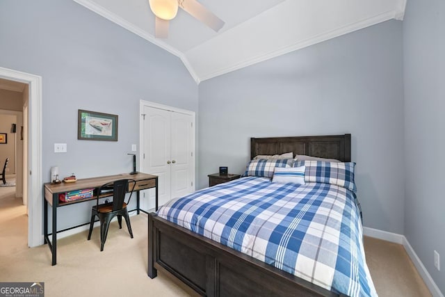 bedroom with lofted ceiling, ornamental molding, light colored carpet, and a closet