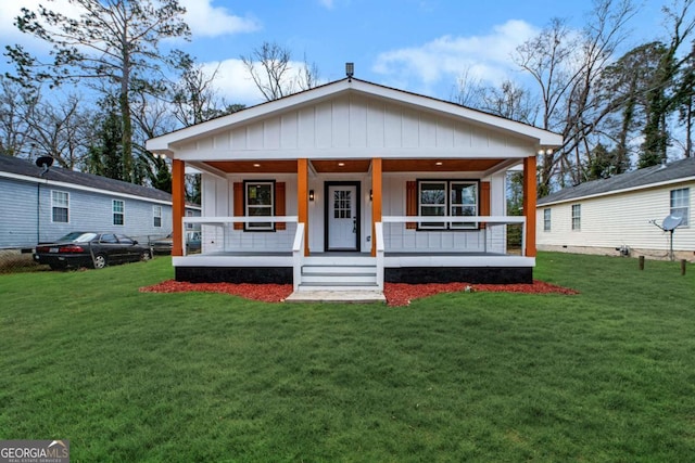 bungalow-style house featuring covered porch and a front yard