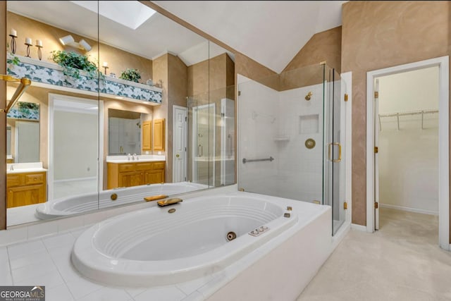 bathroom with vanity, shower with separate bathtub, and vaulted ceiling with skylight