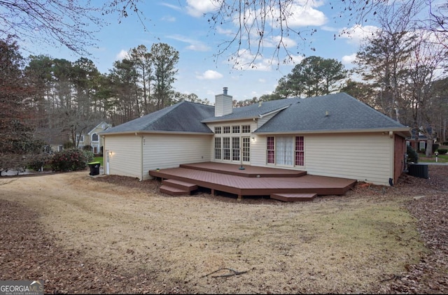 back of property featuring a wooden deck, central AC unit, and a lawn