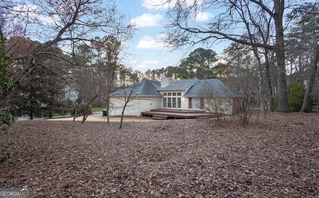 back of house with a wooden deck