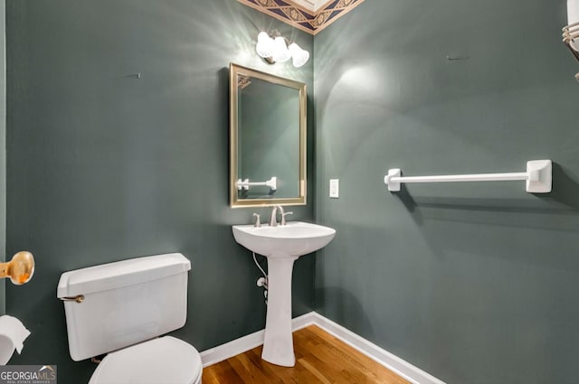 bathroom with toilet and hardwood / wood-style floors