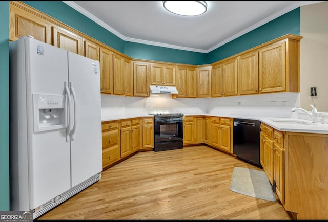 kitchen with sink, crown molding, black appliances, light wood-type flooring, and backsplash