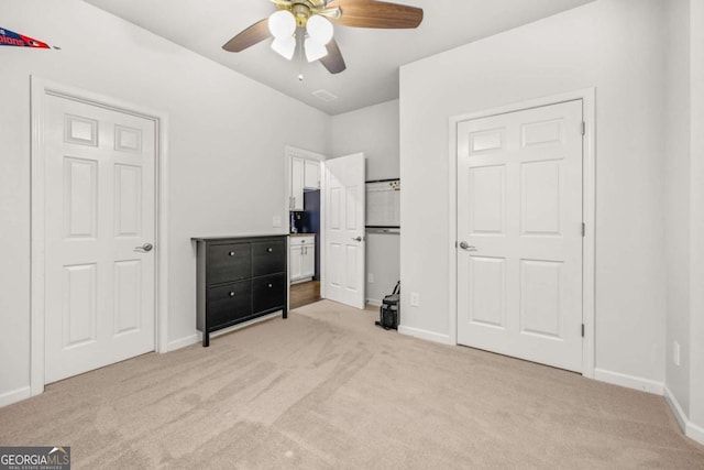 bedroom with light carpet, visible vents, baseboards, and a ceiling fan