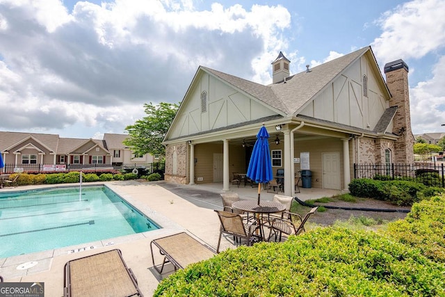 community pool with a patio, grilling area, fence, and a ceiling fan