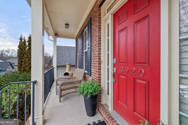 doorway to property featuring brick siding