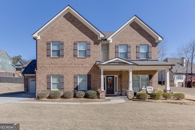 view of front facade with concrete driveway and brick siding